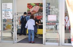死亡事故があったオーケー東伏見店のエスカレーターを調べる関係者（奥）ら＝１２日午後０時３２分、東京都西東京市