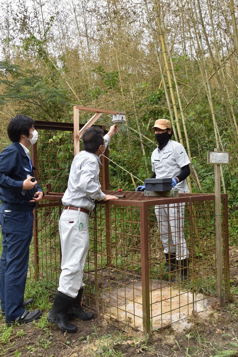 有害鳥獣捕獲用の箱わなにセンサーを取り付ける事業者＝南房総市