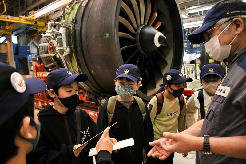 巨大なエンジンのある整備センターを見学する芝山小の児童＝成田市