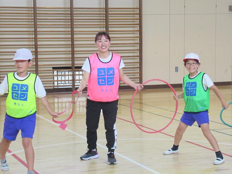 授業の前にはゲームで児童と打ち解けた樋口さん(中央)