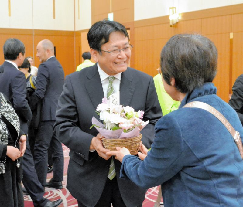 当選が確実になり、支持者から祝福を受ける神谷氏（中央）＝１６日、千葉市中央区
