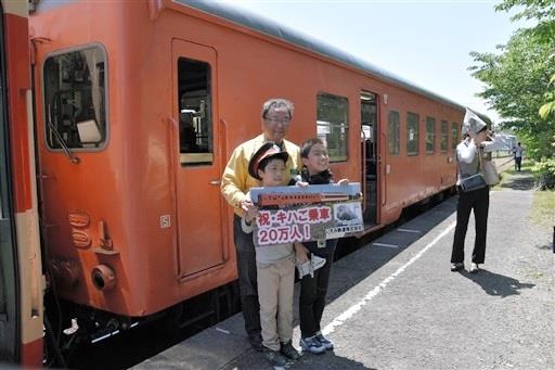 キハ52の前で、鳥塚亮社長(当時)と一緒に記念撮影する20万人目の乗客者=2018年5月、大多喜駅