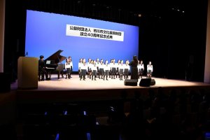 記念式典で合唱を披露する国府台女子学院小学部の児童ら＝市川市文化会館
